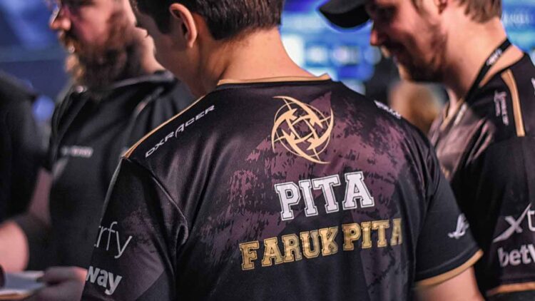 a man wearing a black shirt with gold text